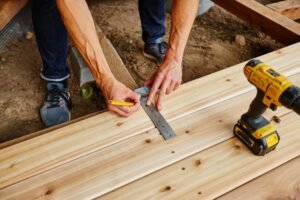 Professional technicians working on damaged wooden boards during a Deck Repair Ajax, ON project.