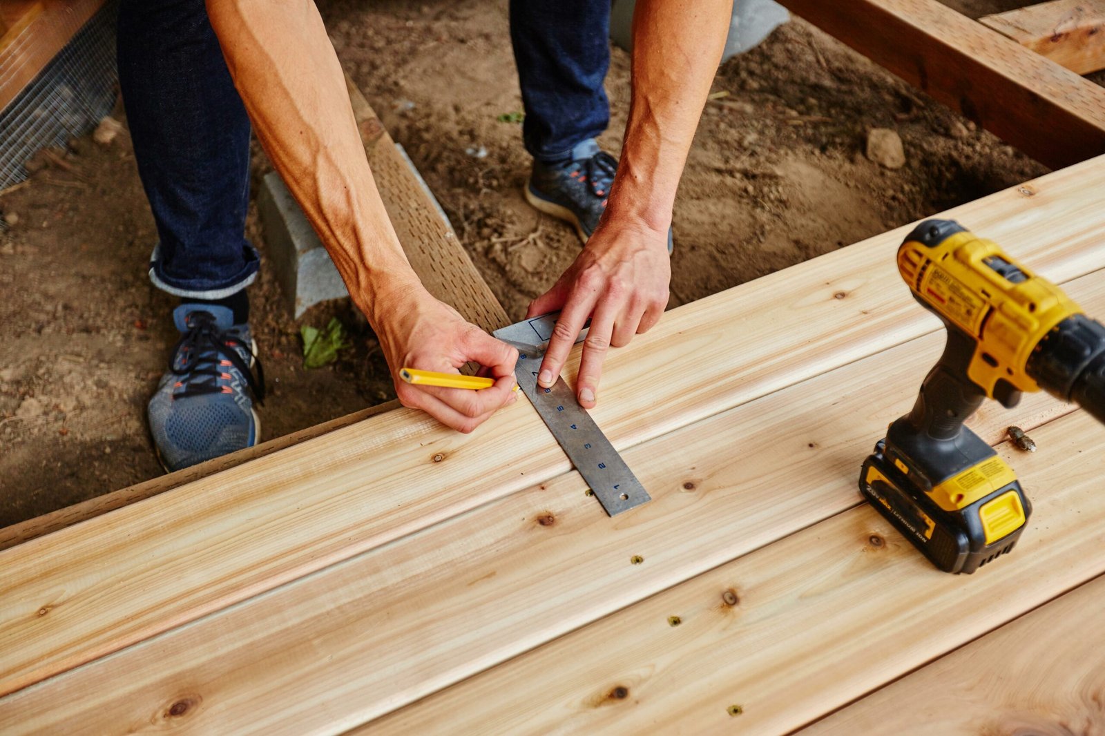 Professional technicians working on damaged wooden boards during a Deck Repair Ajax, ON project.