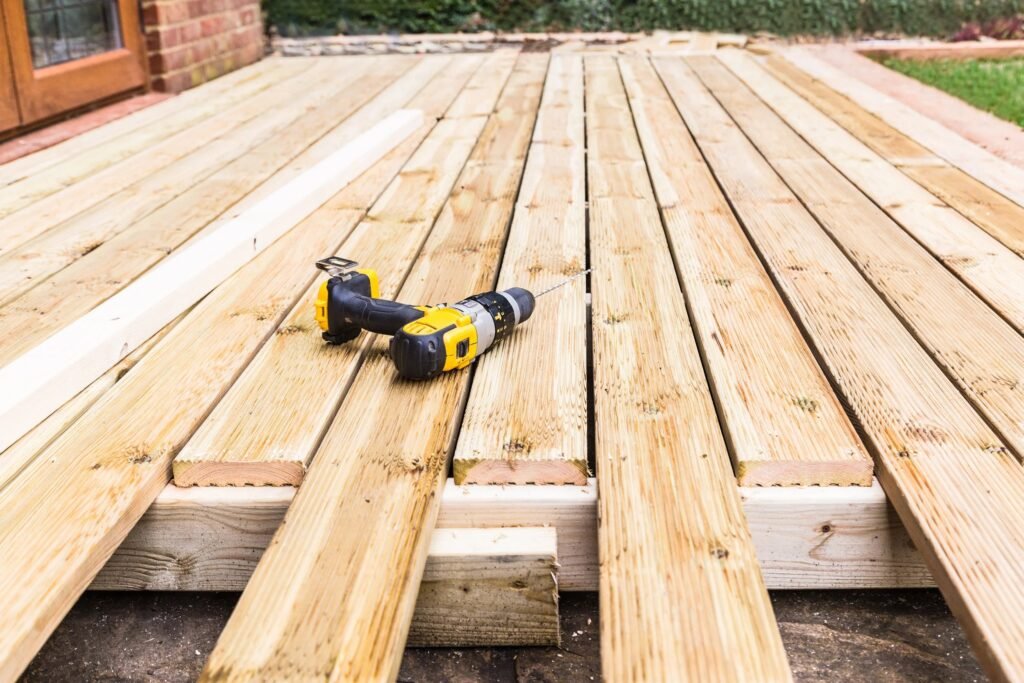 Professional technicians working on damaged wooden boards during a Deck Repair Ajax, ON project.