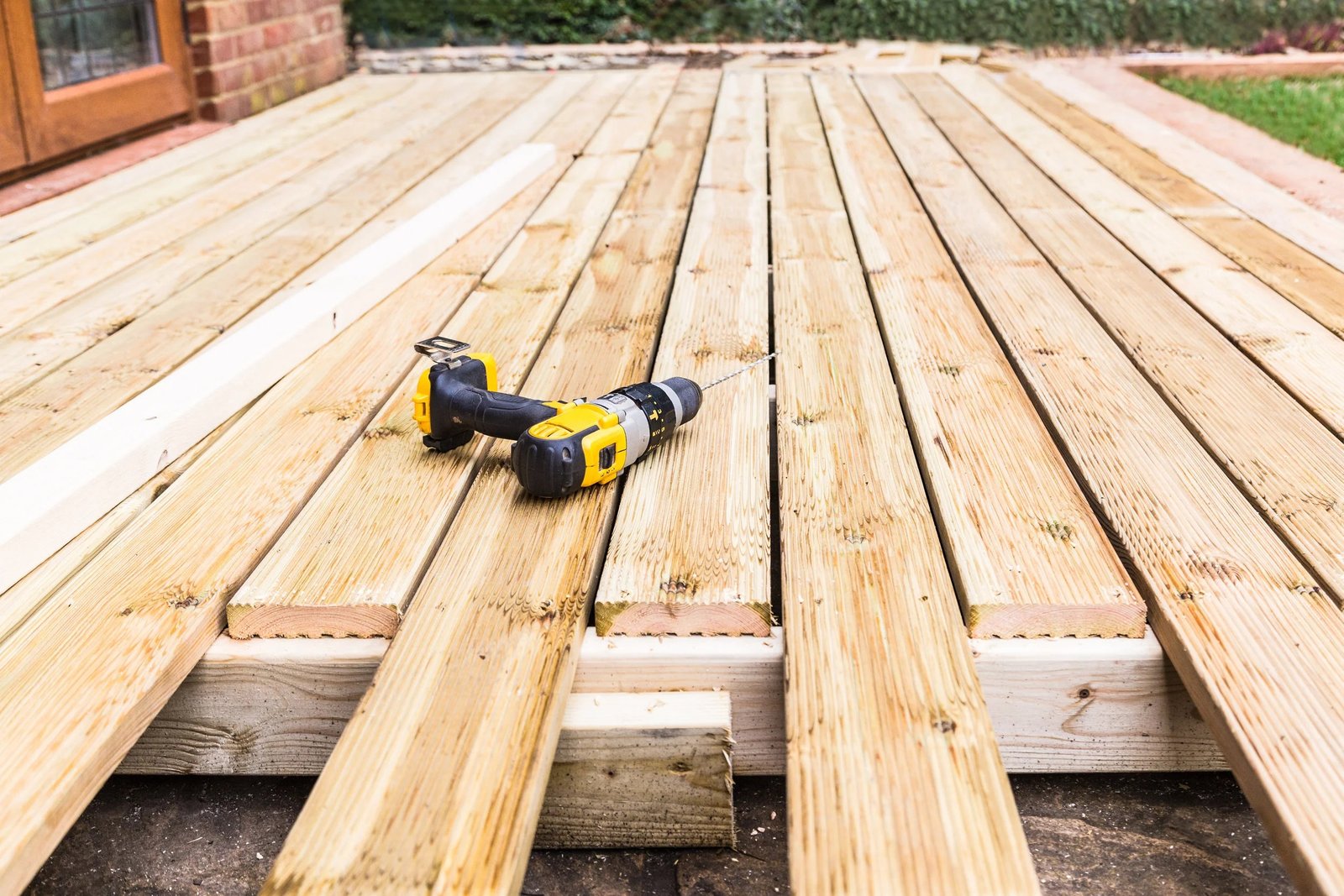 Professional technicians working on damaged wooden boards during a Deck Repair Ajax, ON project.